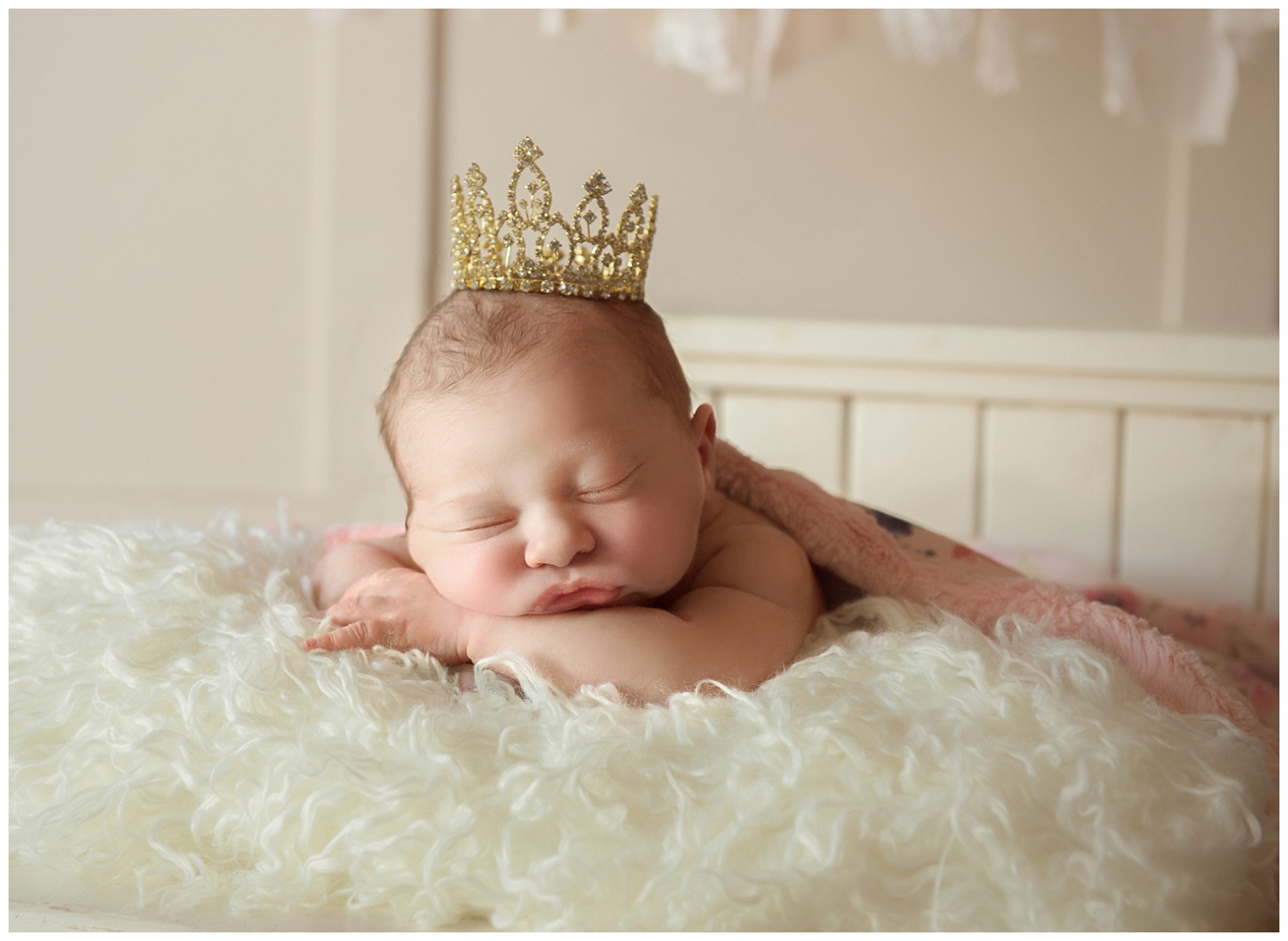 Minnesota Posed Newborn Photographers | Baby posed on a bed with a crown